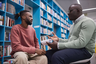 Psychologist with teen in library